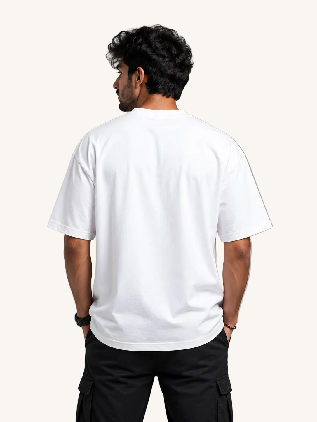 Person wearing a plain white t-shirt on a gray background