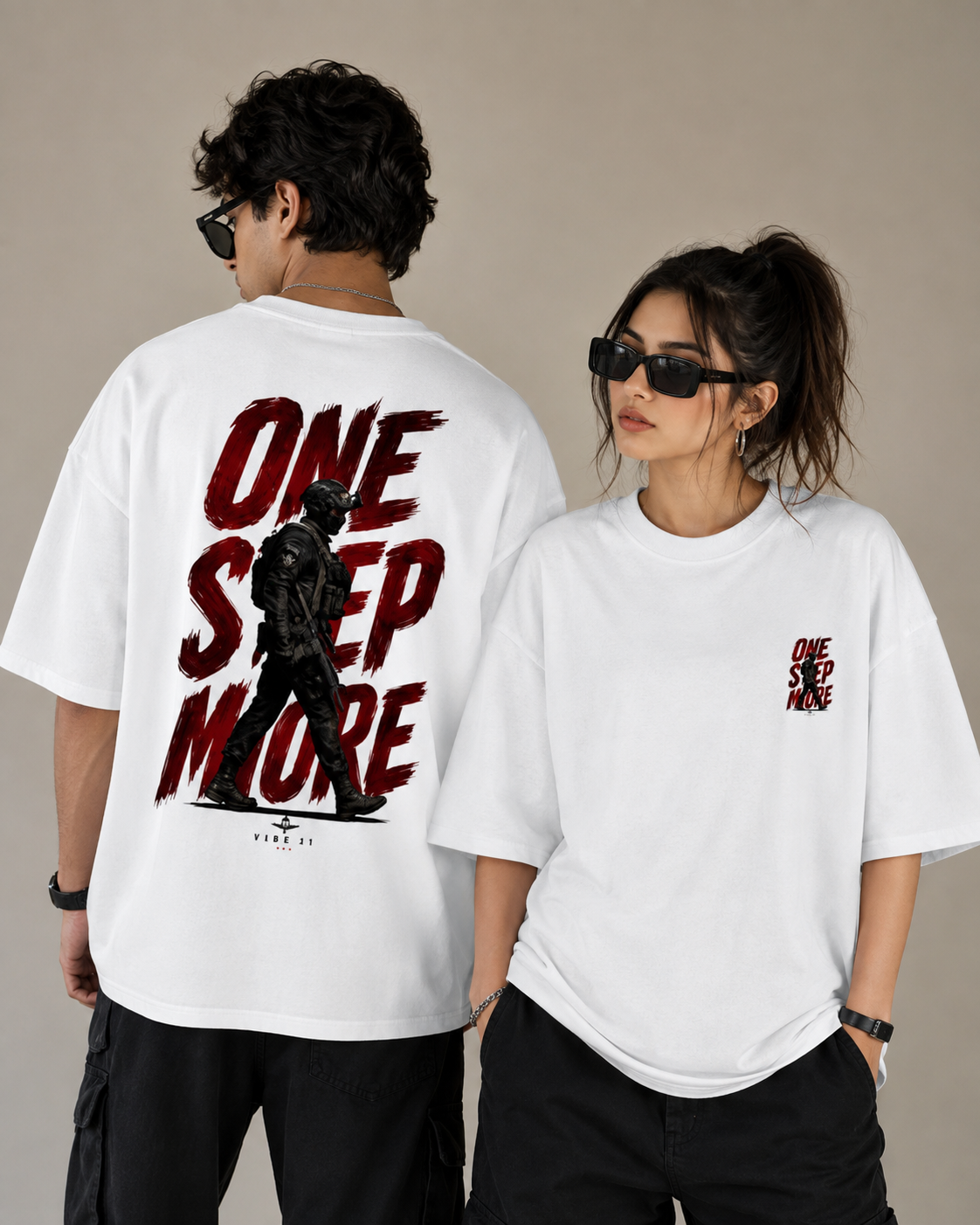 Two models wearing white oversized t-shirts with a red and black 'ONE STEP MORE' graphic. The model on the left shows the back of the shirt with a large black graphic and text, while the model on the right shows the front left-chest print of the same design.