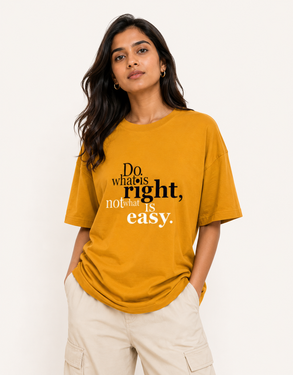 Woman wearing a mustard yellow t-shirt with a motivational quote on a white background