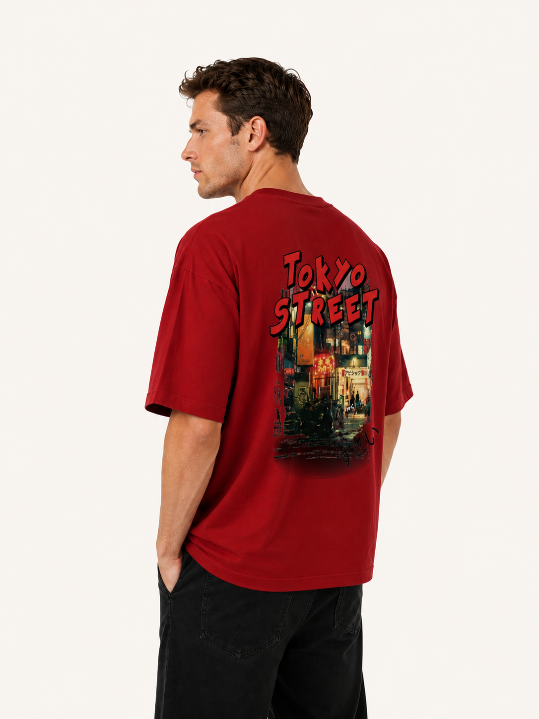 Man wearing a red t-shirt with 'Tokyo Street' design on the back, standing against a white background.
