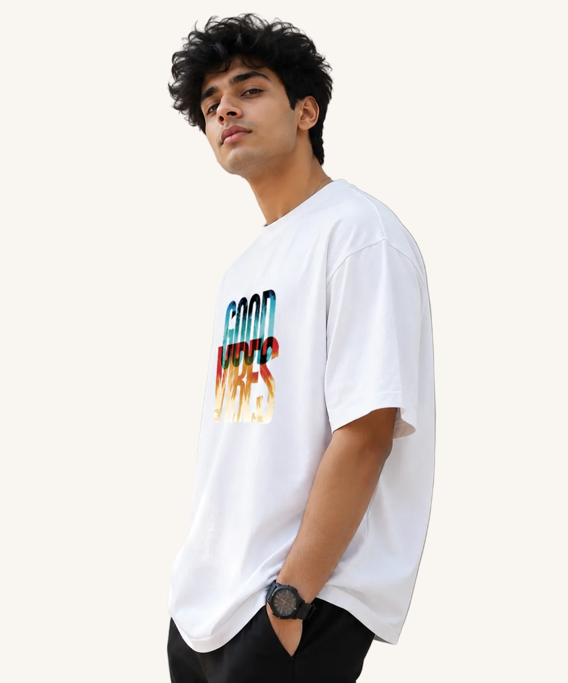 Person wearing a white t-shirt with 'Good Vibes' text in colorful letters against a plain background