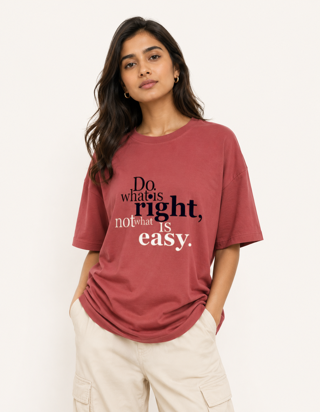 Woman wearing a red t-shirt with a motivational quote on a plain background