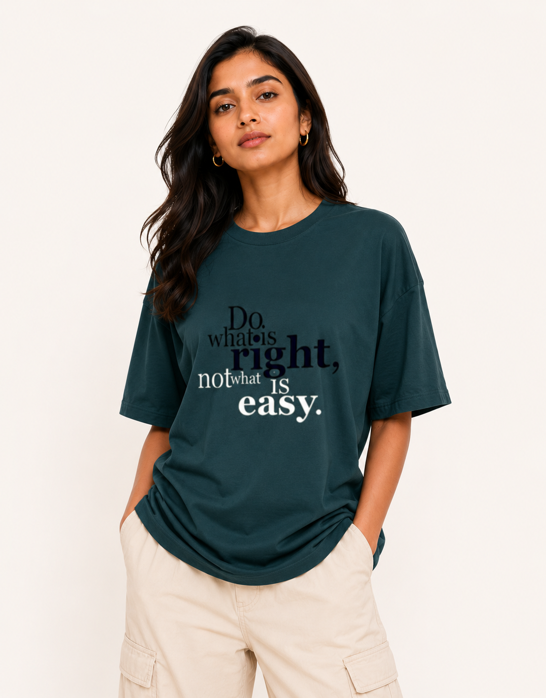 Woman wearing a green t-shirt with a motivational quote on a plain background