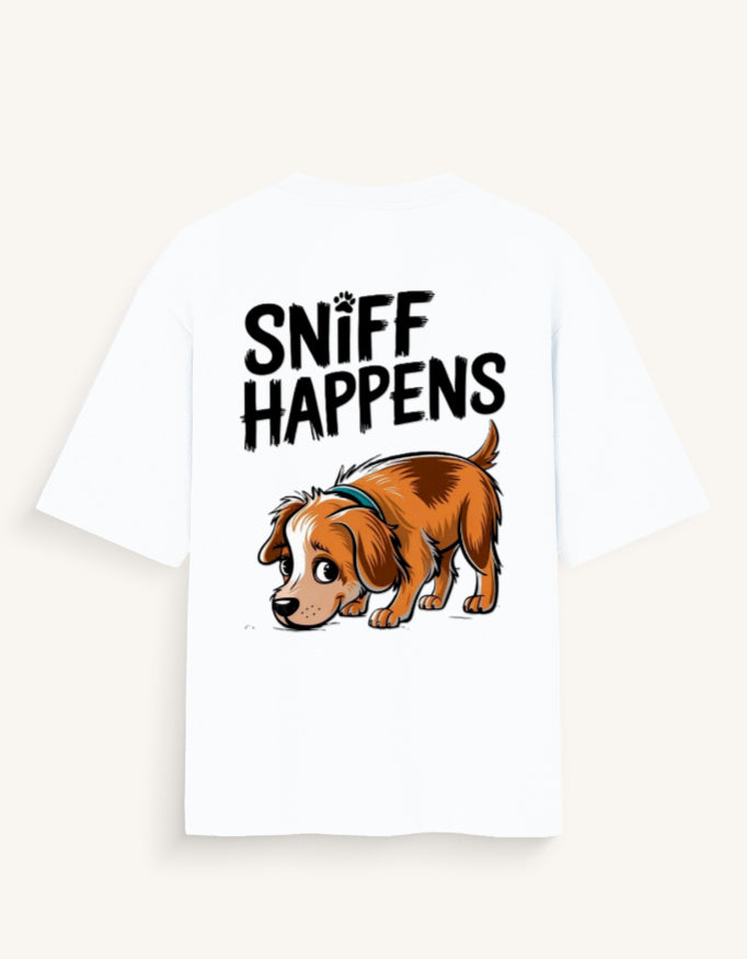 A white short-sleeve t-shirt featuring a graphic print of a brown cartoon dog wearing a blue collar and the text 'SNIFF HAPPENS' in black above it, displayed against a light beige background.
