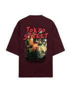 A dark maroon short-sleeve t-shirt shown from the back, featuring a large graphic print of a Tokyo street scene with red 'TOKYO STREET' text.