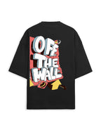 A black oversized short-sleeve t-shirt with a large graphic print on the back. The graphic features the text 'OFF THE WALL' in bold white 3D letters with gray shadows, set against a red and yellow comic-style background.