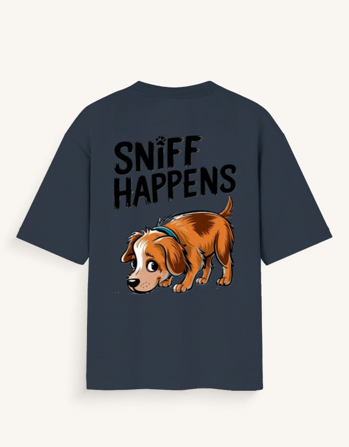 A navy blue short-sleeve t-shirt with a graphic print on the back. The print features the text 'SNIFF HAPPENS' in a black distressed font above a cartoon illustration of a brown and white dog wearing a blue collar, set against a light off-white background.