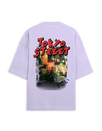 A light purple short-sleeve t-shirt shown from the back, featuring a large graphic print of a Tokyo street scene with bold red 'TOKYO STREET' text.
