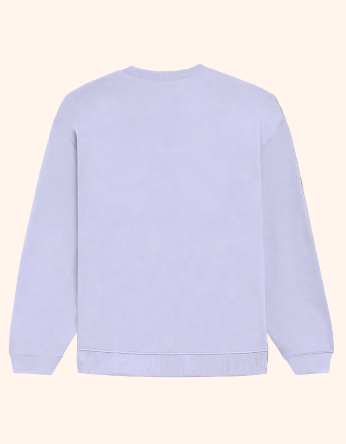 A plain white crewneck sweatshirt shown from the back, laid flat against a solid beige background.