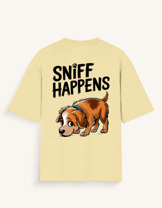 A pale yellow short-sleeve t-shirt with a graphic print on the back featuring the text 'SNIFF HAPPENS' above a cartoon illustration of a brown and white dog.