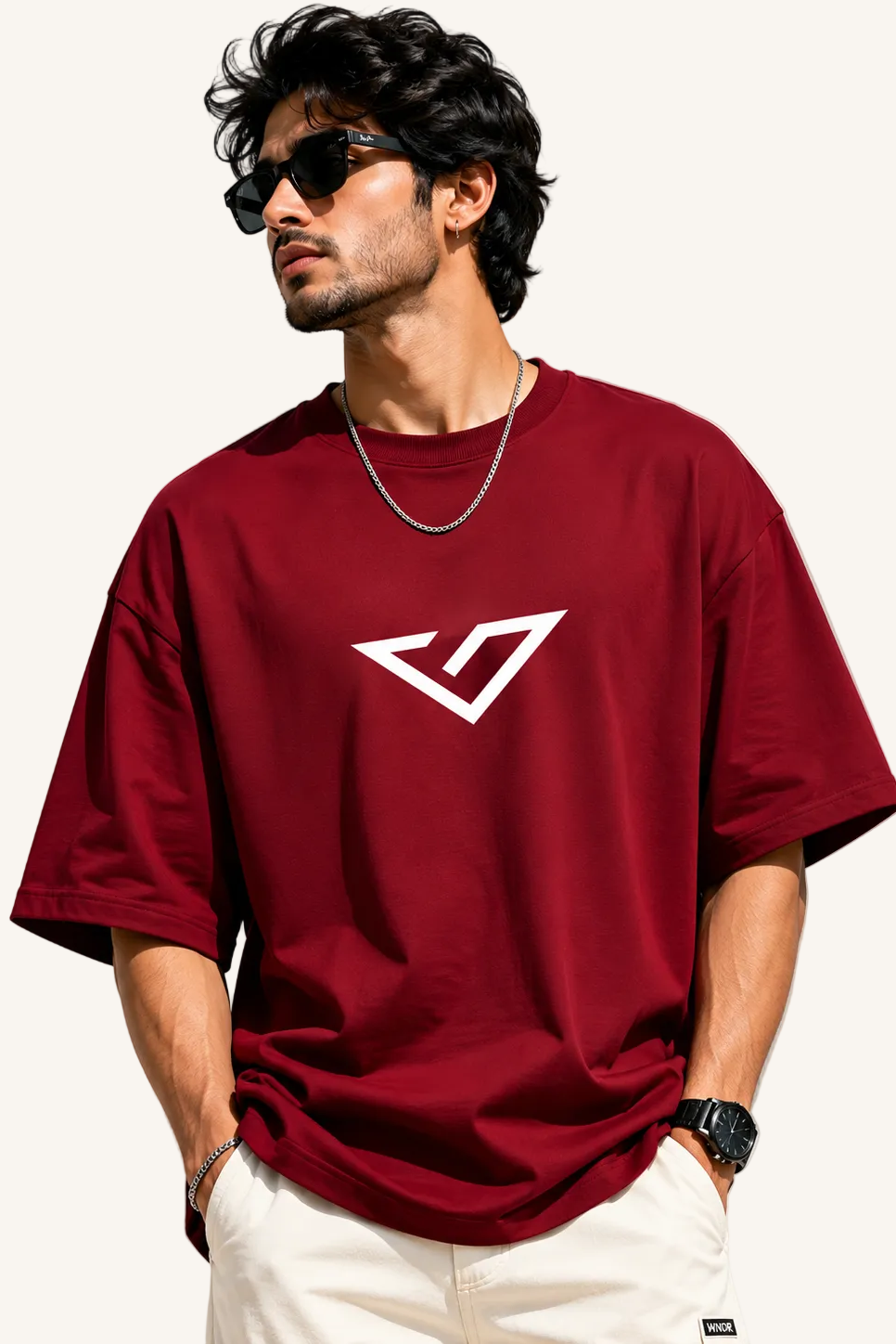 Man wearing a red t-shirt with a white logo on a plain background