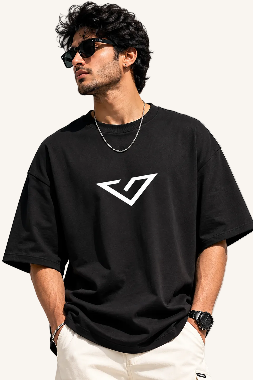Man wearing a black t-shirt with a white logo on a plain background