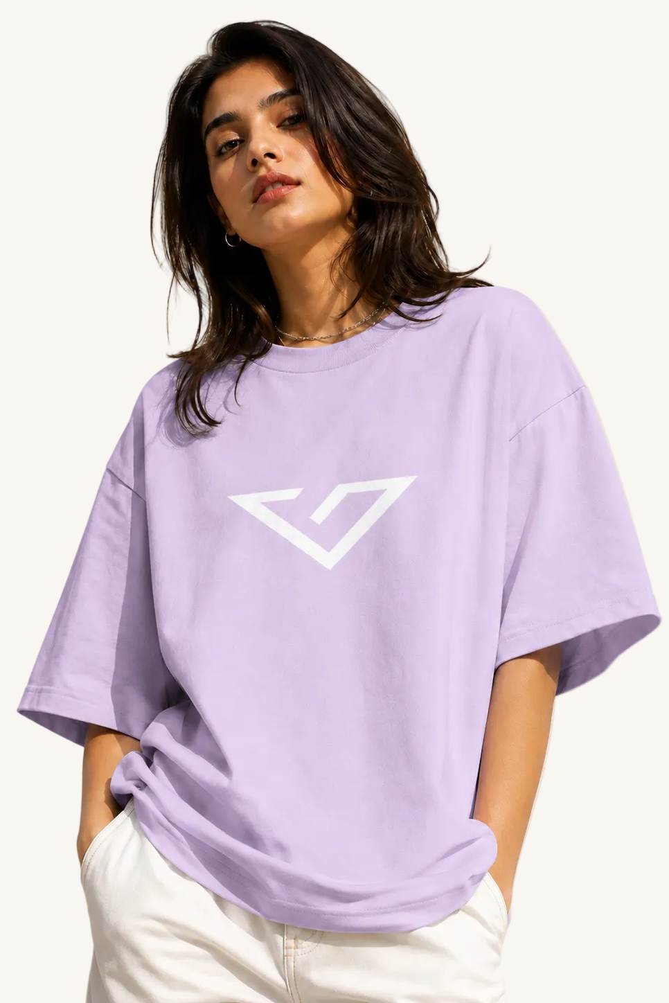 Woman wearing a light purple t-shirt with a logo on a beige background