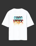 A white short-sleeve crewneck t-shirt featuring a colorful graphic print on the chest that reads 'GOOD VIBES' in a watercolor-style gradient of blue, red, and orange.