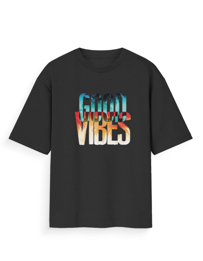 A black short-sleeve t-shirt with a colorful graphic text print reading 'GOOD VIBES' in a retro gradient font, displayed on a clean white background.