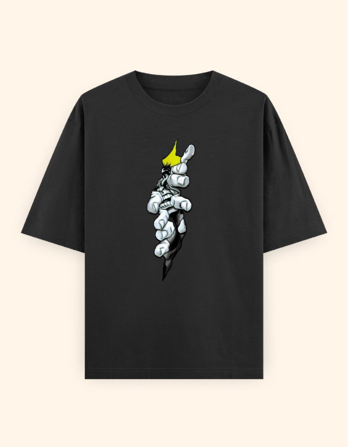 A black short-sleeve crewneck t-shirt featuring a graphic print of a hand tearing open the fabric to reveal a white and gray skeletal hand with a yellow crown, set against a solid cream background.