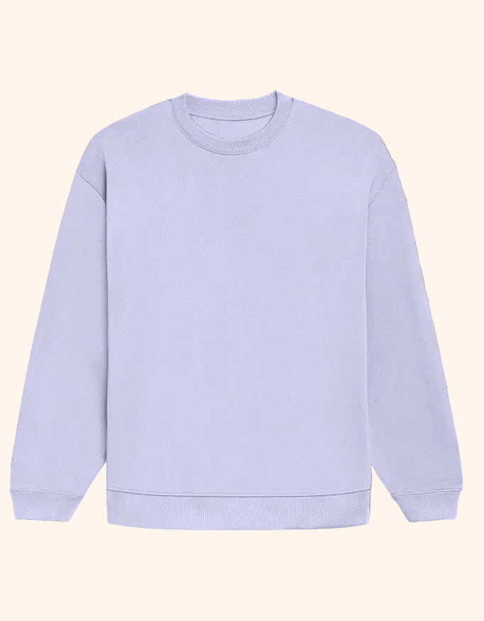 A plain crewneck sweatshirt in a very light lavender-purple color, laid flat against a solid warm beige background.
