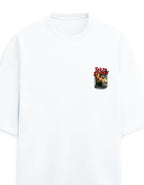 A white short-sleeve crewneck t-shirt with a small graphic print on the left chest depicting red roses and a burning building.