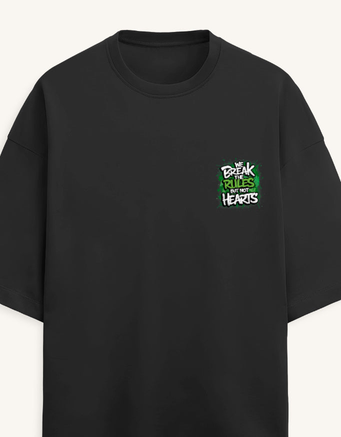 A black short-sleeve crewneck t-shirt with a small graphic on the left chest that reads 'BREAK THE RULES WITH HEARTS' in white and green, displayed against a light off-white background.