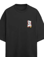 A black oversized short-sleeve t-shirt with a small multicolor graphic on the left chest reading 'OFF THE WALL' in a stylized font, shown against a plain white background.
