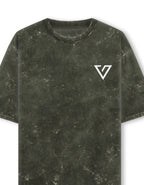 A short-sleeve crewneck t-shirt in a dark olive green mineral-wash or distressed texture, featuring a white stylized 'V' logo on the left chest, shown against a plain white background.