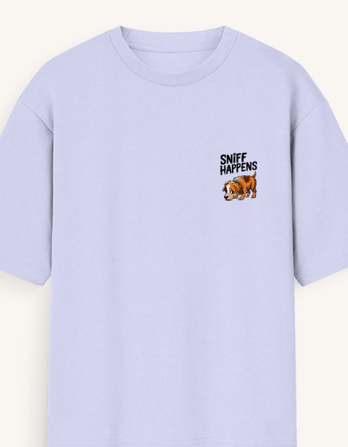 A light lavender crewneck t-shirt with a small graphic on the left chest featuring the text 'SNIFF HAPPENS' above a cartoon bulldog, shown against a light cream background.