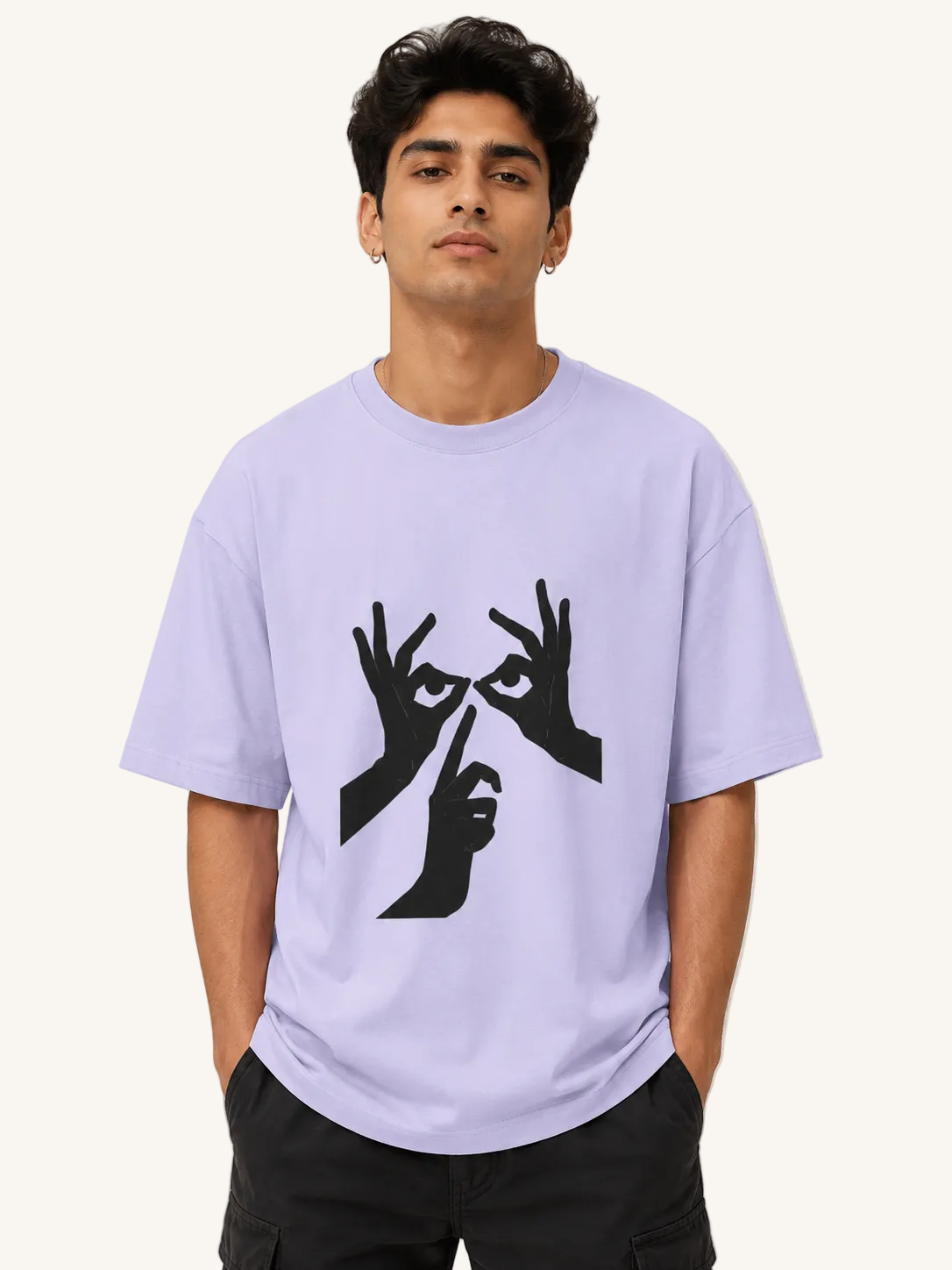 Person wearing a light purple t-shirt with black graphic design on a plain background