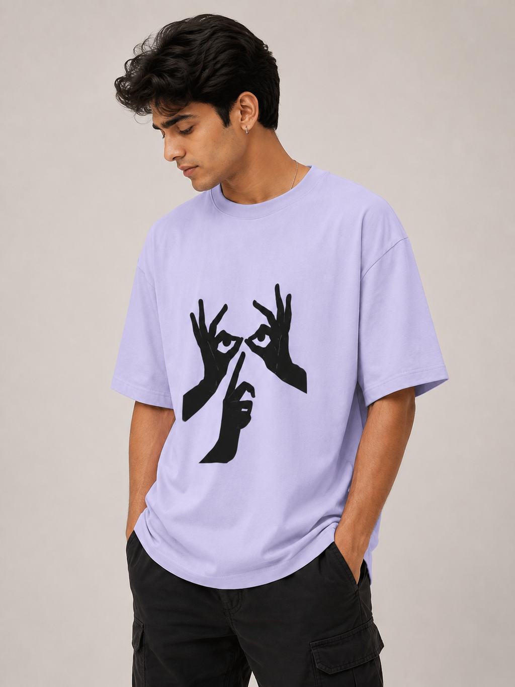 Person wearing a light purple t-shirt with a black graphic design on a plain background
