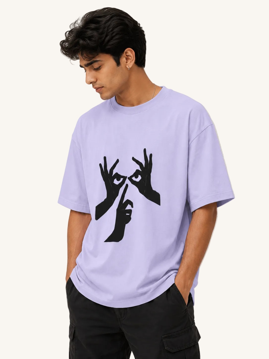 Person wearing a light purple t-shirt with a black graphic design on a plain background