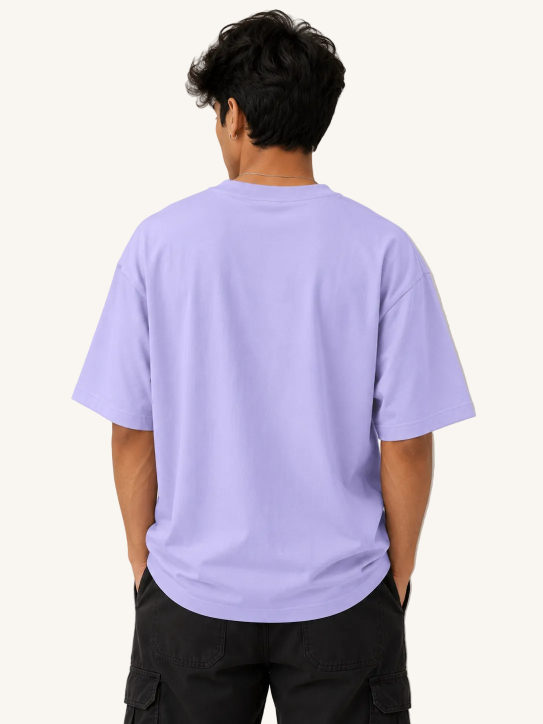Person wearing a light purple t-shirt against a plain background