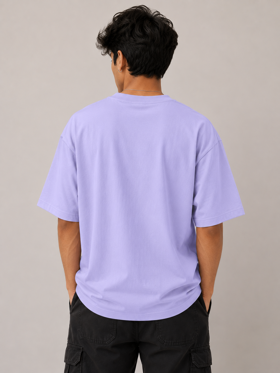 Person wearing a light purple t-shirt against a plain background