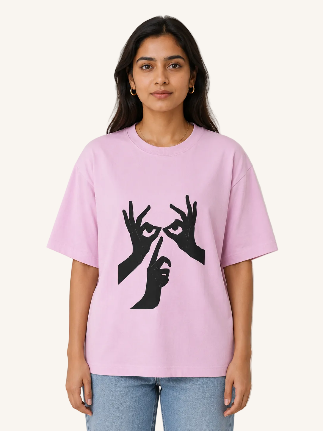Person wearing a pink t-shirt with black graphic design on a plain background