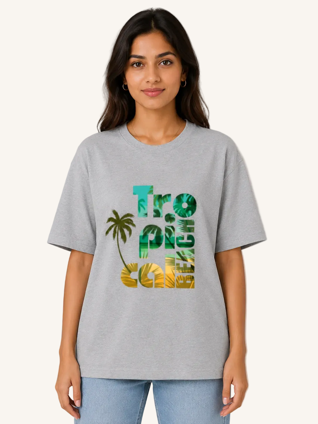 Woman wearing a gray t-shirt with 'Tropical' design on a beige background