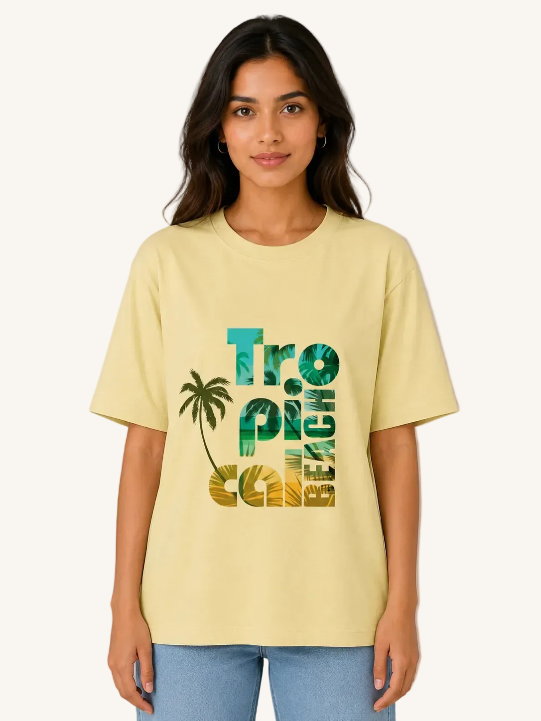 Woman wearing a light yellow t-shirt with 'Tropical' design on a plain background