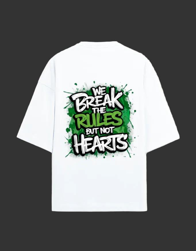 A white short-sleeve t-shirt with a large graphic print on the back featuring the text 'WE BREAK THE RULES BUT NOT HEARTS' in a graffiti-style font over a green paint-splatter background.