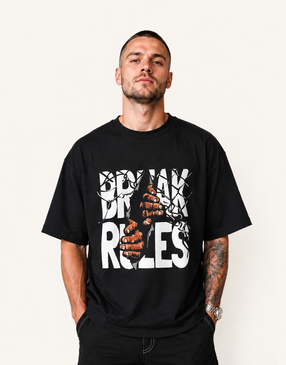 Man wearing a black t-shirt with 'Break Up Rules' graphic design on a plain background