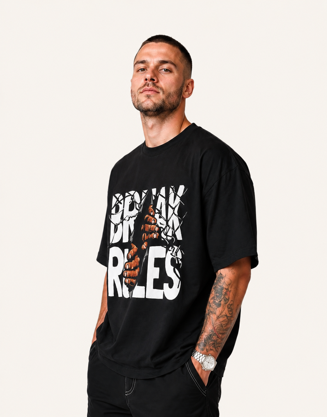 Man wearing a black t-shirt with white text and graphics on a plain background