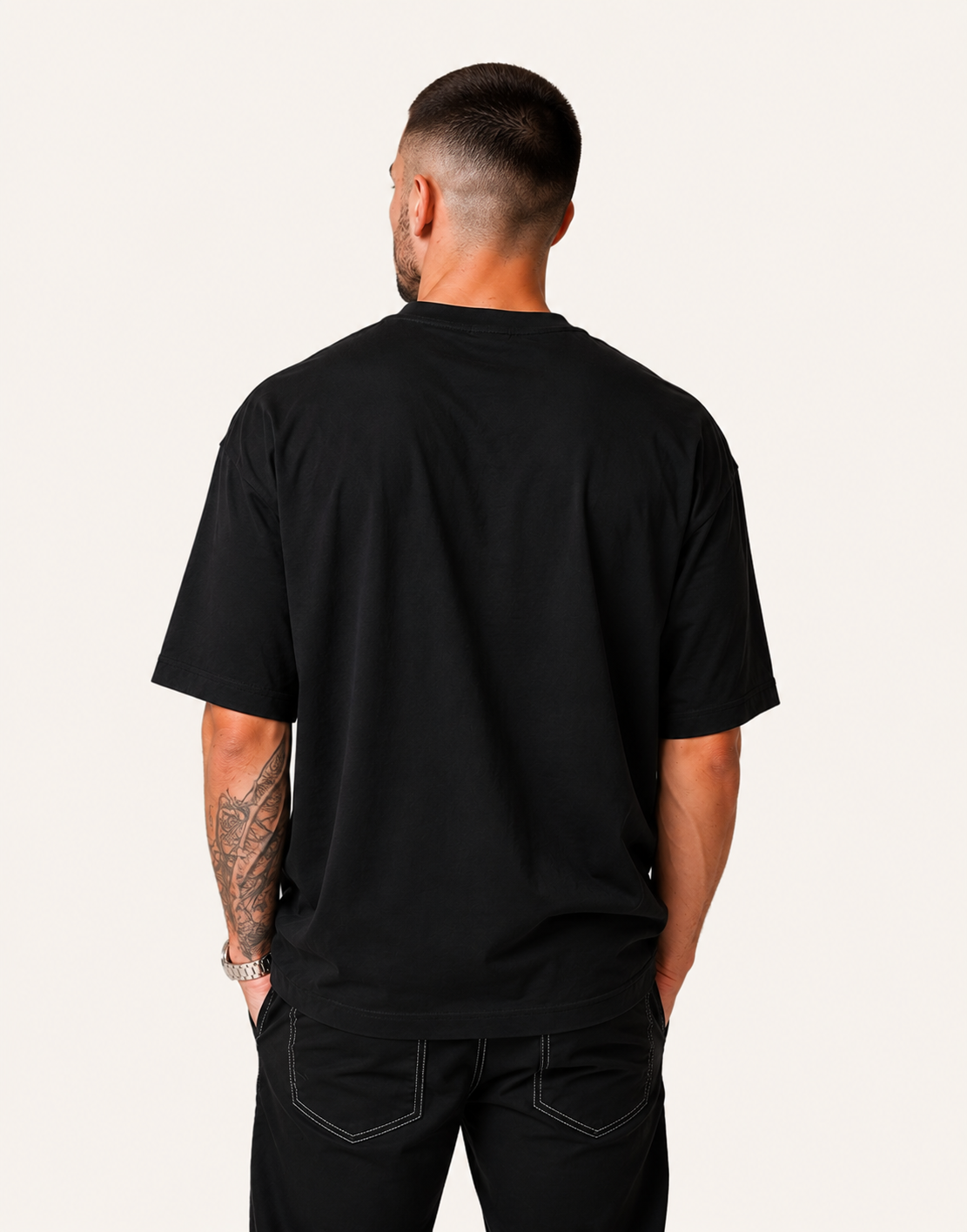Man wearing a black t-shirt and pants on a white background