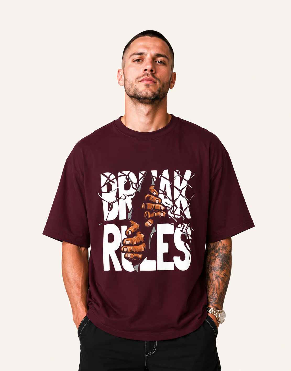 Man wearing a maroon t-shirt with graphic design and text on a plain background