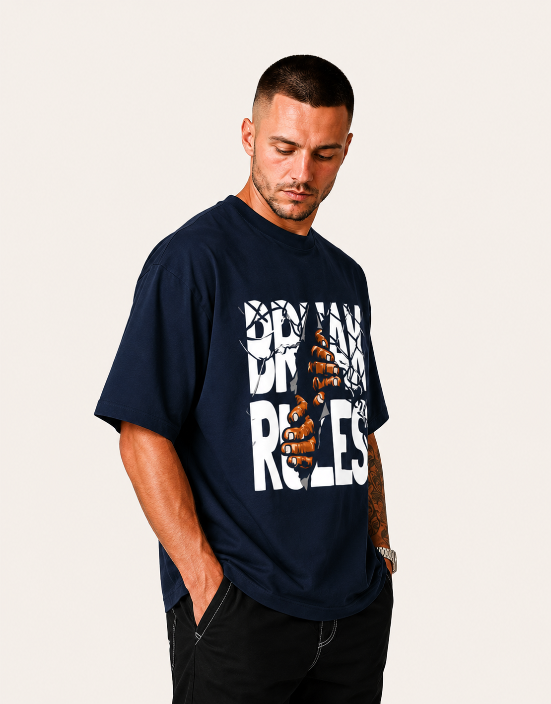 Man wearing a navy blue t-shirt with graphic design and text on a plain background