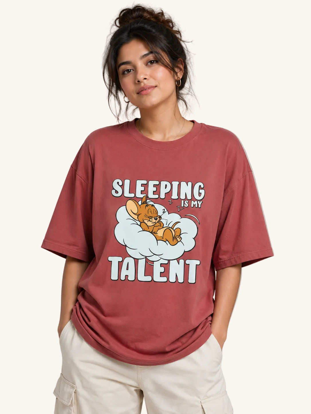 Person wearing a red t-shirt with a cartoon design and text on a plain background