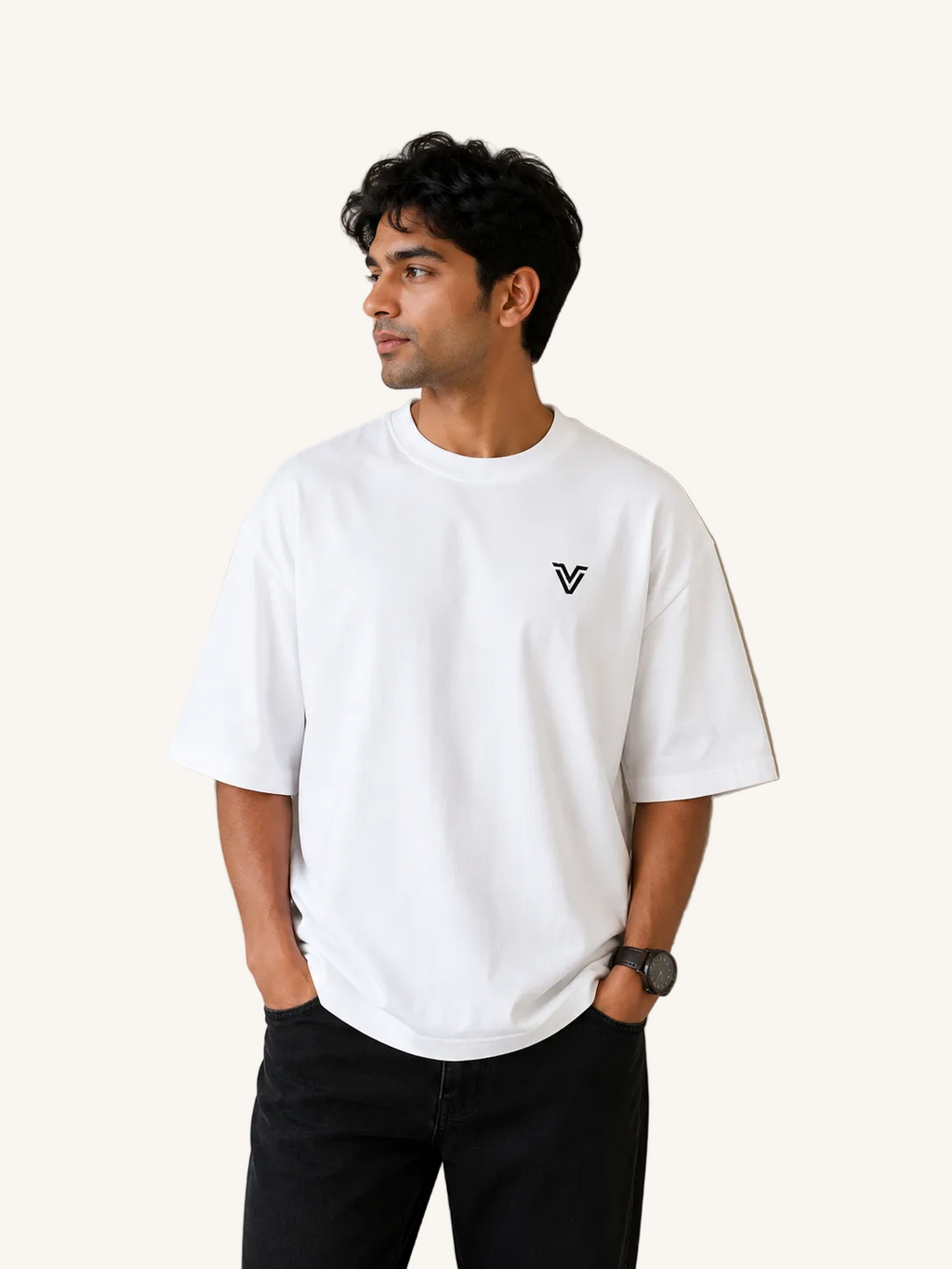Man wearing a white t-shirt with a logo against a plain wall