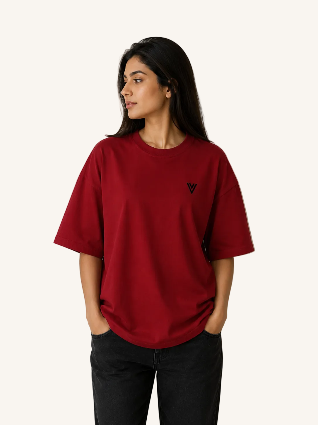 Person wearing a red t-shirt with a small logo against a plain background