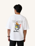 Person wearing a white 'Tom and Jerry' t-shirt with cartoon characters on the back.